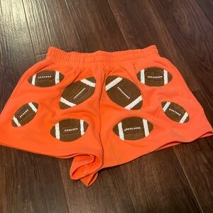 Queen of sparkle, orange football shorts, size medium, new with tags